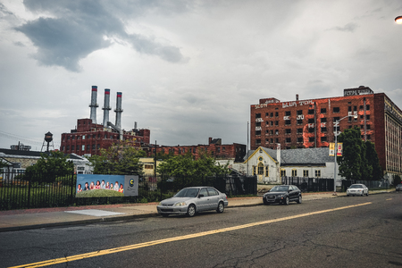 Detroit, Michigan, May 18, 2018: View towards typical Detroit Automotive Factory with water tower and Chimney.のeditorial素材