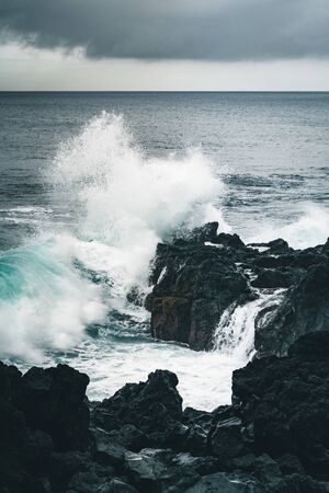 Azores, Big waves crashing over black volcanic rock on the Atlantic Ocean in the coast of Sao Miguel...