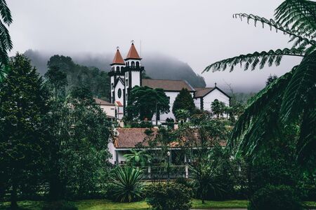 View towards Church of Furnas in Terra Nostra Garden Park on Sao Miguel island, Furnas, Azores. It is located in the midst of this magnificent water system.の写真素材
