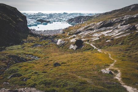 View towards Icefjord in Ilulissat. Easy hiking route to the famous Kangia glacier in Greenland. The...