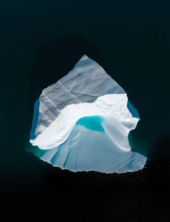 Icebergs drone aerial image top view - Climate Change and Global Warming. Icebergs from melting glacier in icefjord in Ilulissat, Greenland. Arctic North Pole nature ice landscape in Unesco World Heritage Siteの写真素材
