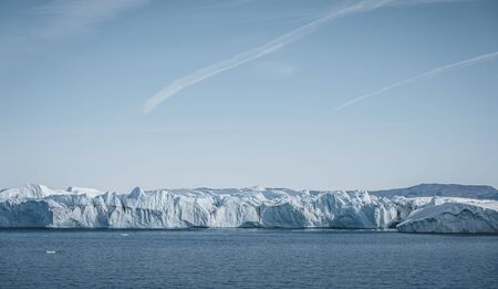 Greenland. The biggest glacier on a planet Jakobshavn. Huge icebergs of different forms in the gulf....