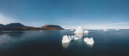 Iceberg and ice from glacier in arctic nature landscape in Ilulissat,Greenland. Aerial drone photo of icebergs in Ilulissat icefjord. Affected by climate change and global warming. Photo taken in Greenland.の写真素材
