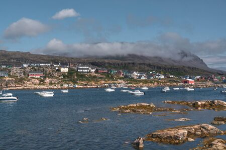 View over colourful greenland houses of Disko Island, arctic city of Qeqertarsuaq. Located in the...