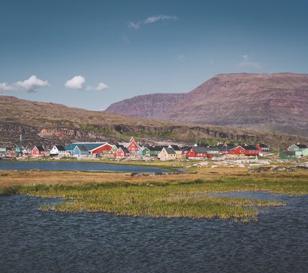 View over colourful greenland houses of Disko Island, arctic city of Qeqertarsuaq. Located in the...