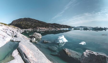 Beautifull landscape with floating icebergs in glacier lagoon and lake in Greenland. Ilulissat Icefjord Glacier. Iceberg and ice from glacier in arctic nature landscape.の写真素材