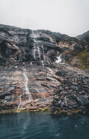Panoramic view of beautiful waterfall coming from a high mountain fjord in west Greenland north of Ilulissat. Photo taken in Greenland.の写真素材