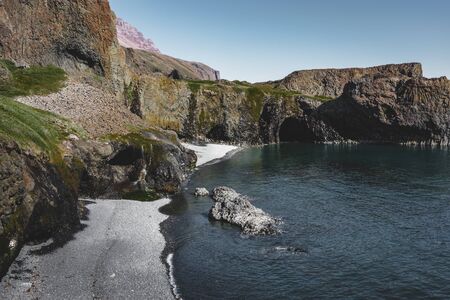 Arctic Beach with small waterfall in Greenland. Near small village of Qeqertarsuaq, Disko Island in...