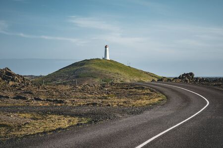 Gunnuhver, Reykjanes peninsula. Geothermal area with Reykjanesviti or Reykjanes lighthouse, the oldest. Powerful caldara of Gunnuhver, in the background.の写真素材