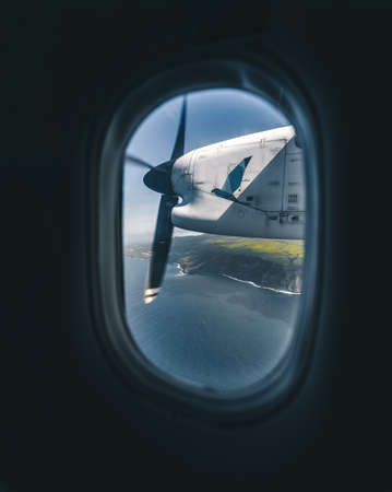 Ponta Delgada Azores - July 13, 2019: Island of Faial seen from SATA Air Acores passenger plane on the way to Horta Airport. Photo taken in Azores, Portugal.のeditorial素材
