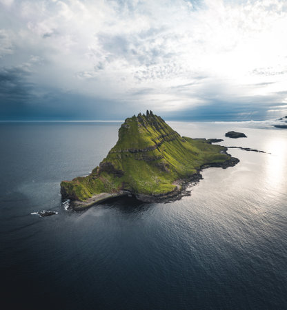 Faroe Islands Vagar, aerial drone view of Tindholmur island during sunset in North Atlantic Ocean. Faroe Islands, Denmark, Europe.の写真素材