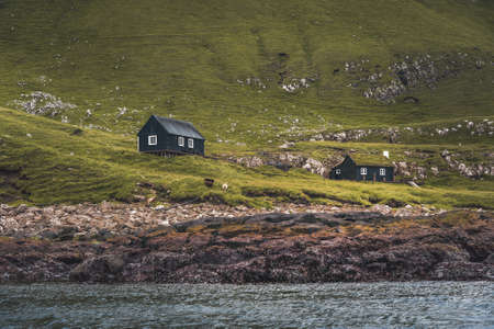 Top view vertical composition with the iconic Drangarnir gate, Tindholmur and mykines island in the background, Faroe Islandsの写真素材