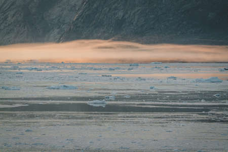 Stranded icebergs in the fog at the mouth of the Icefjord near Ilulissat. Nature and landscapes of...