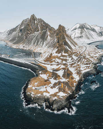 Drone view of a snow covered Eystrahorn mountain in Iceland at Hvalnes peninsula