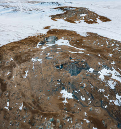 Aerial Drone view of Hverir in Winter with Snow. Icelandic Hverarond is geothermal area in Myvatn,...