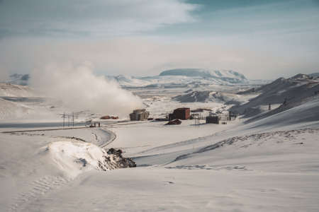Icelandic landscape with geothermal power plant station kravla with igloo huts and pipes in the valley. Myvatn lake surroundings, Icelandの写真素材