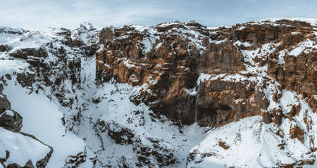 Secret canyon named Mulagljufur canyon in South Iceland. Waterfall below mountain top in winter and snow landscape. Top tourism destination. South East of Iceland, Europeの写真素材