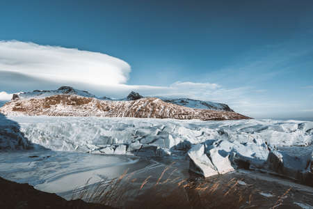 Street Highway Ring road No.1 in Iceland, with view towards massive glacier with beautiful lenticular clouds. Southern side if the country. Road trip travel concept.の写真素材