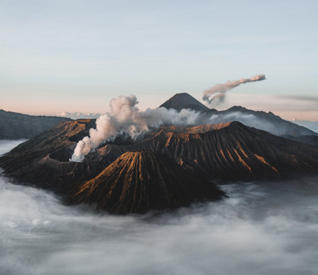 Mount Bromo volcano Gunung Bromo in Bromo Tengger Semeru National Park, East Java, Indonesia. Sunrise with soft light and smoke. Semeru eruption in background.の写真素材