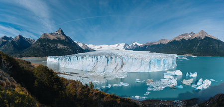 Panoramic view of the gigantic Perito Moreno glacier, its tongue and lagoon in Patagonia, Argentina, sunny day, blue sky.の写真素材