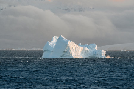 Single iceberg floating in water. Antarctica and Arctic Greenland. Global warming and climate change...