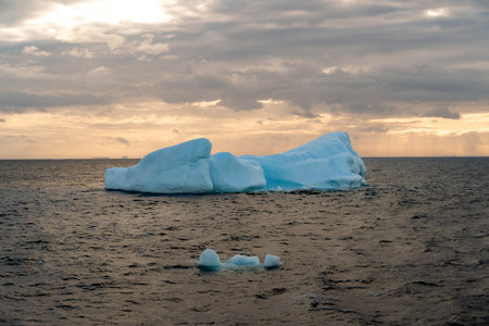 Beautiful iceberg floating in the water. Photo taken at sunset in Antarctica and Arctic Greenland....
