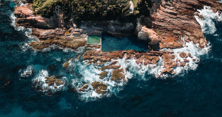 Aerial drone view of Blue Pool in Bermagui during sunrise sunset with blue sky and reflection. New South Wales, Australiaの写真素材