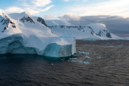 Beautiful snow-capped mountains against the sunset sky in Antarctica. Global warming and travel concept for climate change. Arctic Greenland.の写真素材