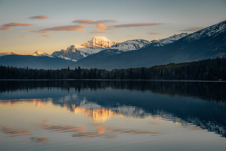 Sunset over Maligne Lake and Evelyn Creek in Jasper National Park, Canada, with snow-covered peaks of canadian Rocky Mountains in the background.の写真素材