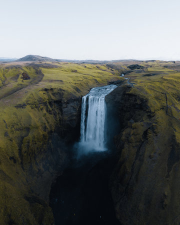 Iceland. Aerial view on the Skogafoss waterfall. Landscape in the Iceland from air. Famous place in Iceland. Landscape from drone. Travel concept. Sunset and sunrise. Soft light.の写真素材