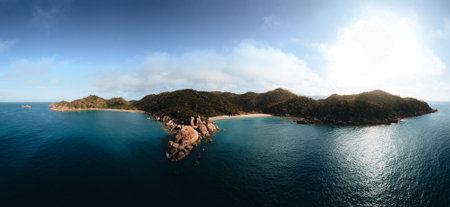 Panorama aerial drone view of Radical Bay Beach at Arcadia at Magnetic Island near Townsville in Queensland, Australia - Aerial drone footage with rocks, waves, cliffs, ocean, trees, coast, views and scenery.の写真素材