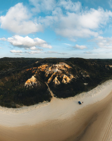 Aerial Drone view of The Pinnacles, Colored Sands on Fraser Island, Sunrise with car. Kgari, Queensland, Australia.の写真素材