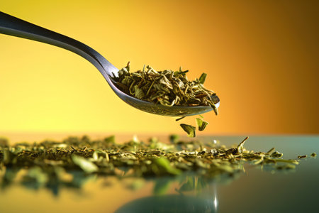 tea strands on a metllaic spoon with a background studioの素材