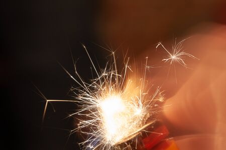 Abstract electric spark from a lighter isolated on a black background.の写真素材