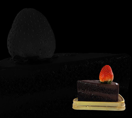 Chocolate cake and Strawberry placed on gloden tray on black backgroundの写真素材