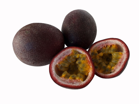 Tropical Fruit. Two whole passion fruit and a cut passion fruit on white background.の写真素材