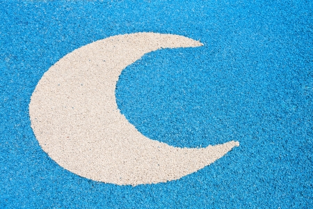 White  half moon on blue asphalt roadの写真素材