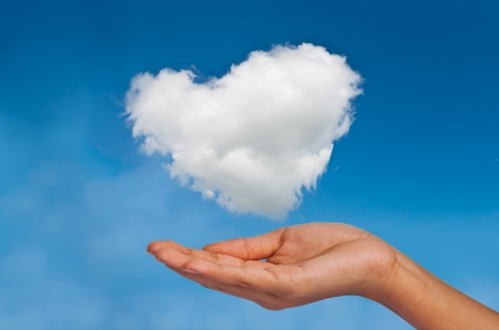 Give cloud heart to you by handの写真素材
