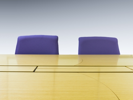 Meeting room with wood table and armchairs   Office interior 