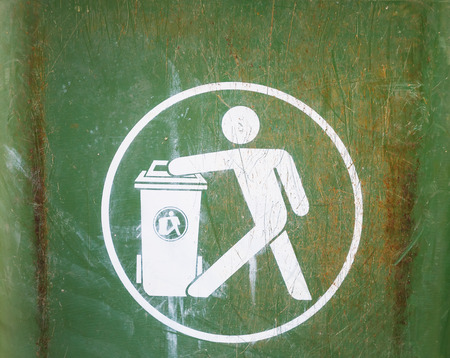 White sign on used dirty green garbage binの写真素材