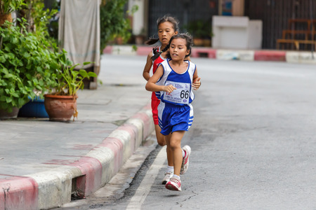 CHONBURI, THAILAND - 20 JULY 2014 - Unidentified athlete runs in twelfth Walk and Run Phanat Nikhom Supper Mini-marathon race at Phanat Nikhom district, Chonburi, Thailand.のeditorial素材