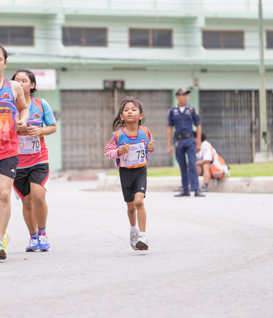 CHONBURI, THAILAND - 20 JULY 2014 - Unidentified athlete runs in twelfth Walk and Run Phanat Nikhom Supper Mini-marathon race at Phanat Nikhom district, Chonburi, Thailand.のeditorial素材