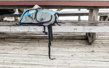 Camera bag on wooden bench for photographyの写真素材