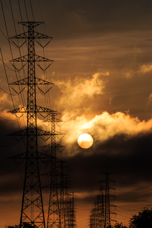 Silhouette electrical power tower with sunlight and cloudの写真素材