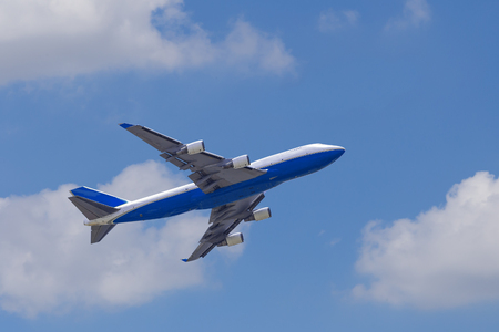 Boeing 747-400 airplane againt blue sky after take offのeditorial素材