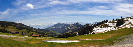 Landscape view of Apls snow mountain with electrical tram and flower grass, panoramaの写真素材