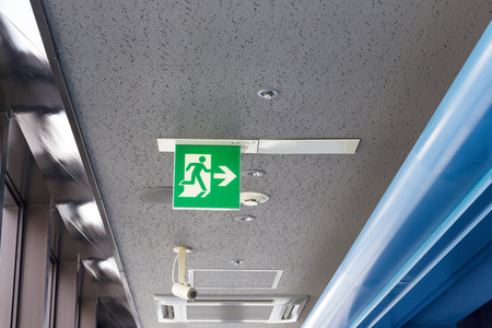 Exit sign lignt with cctv and camera under ceiling for security in the building