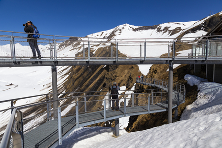 GRINDELWALD BERNE, SWITZERLAND- APRIL 24, 2018 : Traveller are resting and photograph on sky cliff walk at First peak of Alps mountain Grindelwald Switzerlandのeditorial素材