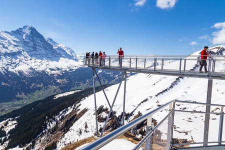 GRINDELWALD BERNE, SWITZERLAND- APRIL 24:Traveller are walking on sky cliff walk at First peak of Alps mountain Grindelwald Switzerland , APRIL 24,2018, Berne, Switzerland. Traveller are resting and photograph on sky cliff walk at First peak of Alps mountのeditorial素材