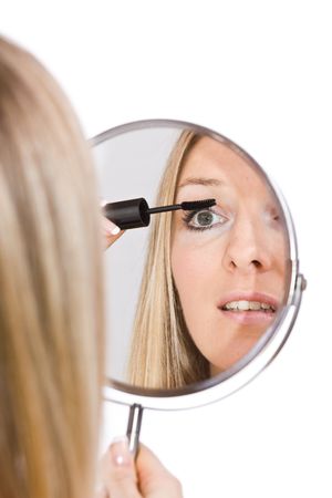 Woman reflection in mirror during makeupの写真素材